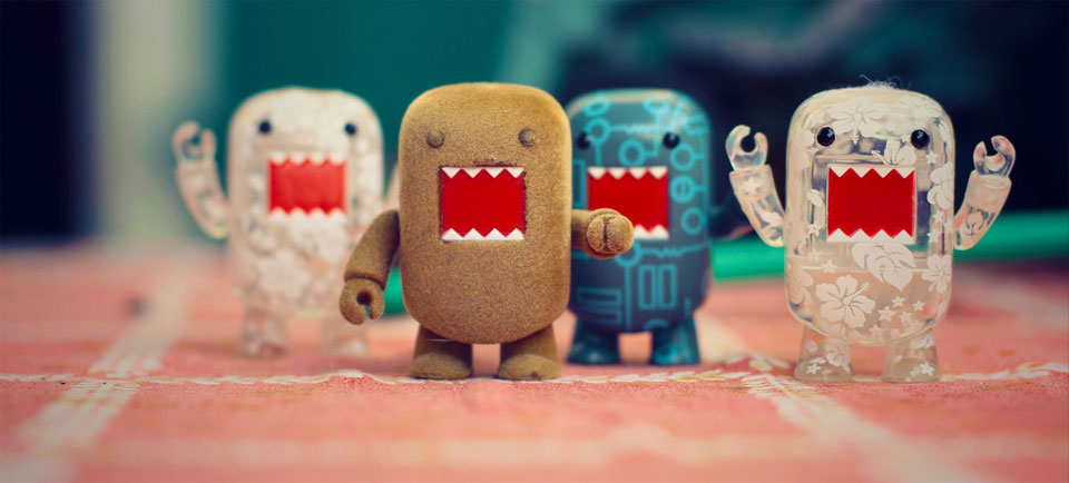 A photo of small toys with big mouths together and punching the air triumphantly.