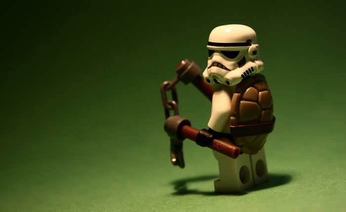 A photo of a Stormtrooper lego toy dressed in a Teenage Mutant Ninja Turtle outfit.