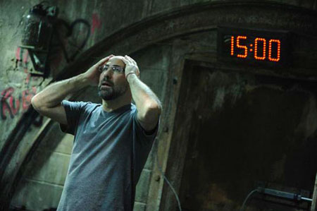 A movie screenshot of a game player holding his head in despair with a countdown time behind him