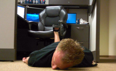 An image of a digital project manager fallen face first off his chair onto the floor.