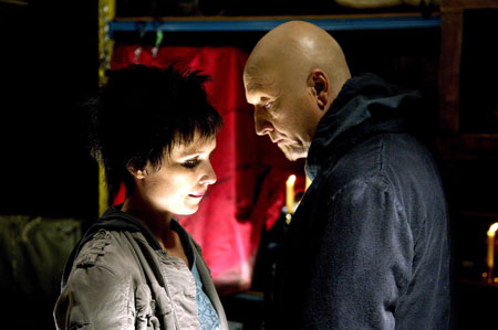 A movie screenshot of Jigsaw talking to Amanda in a dominating manner